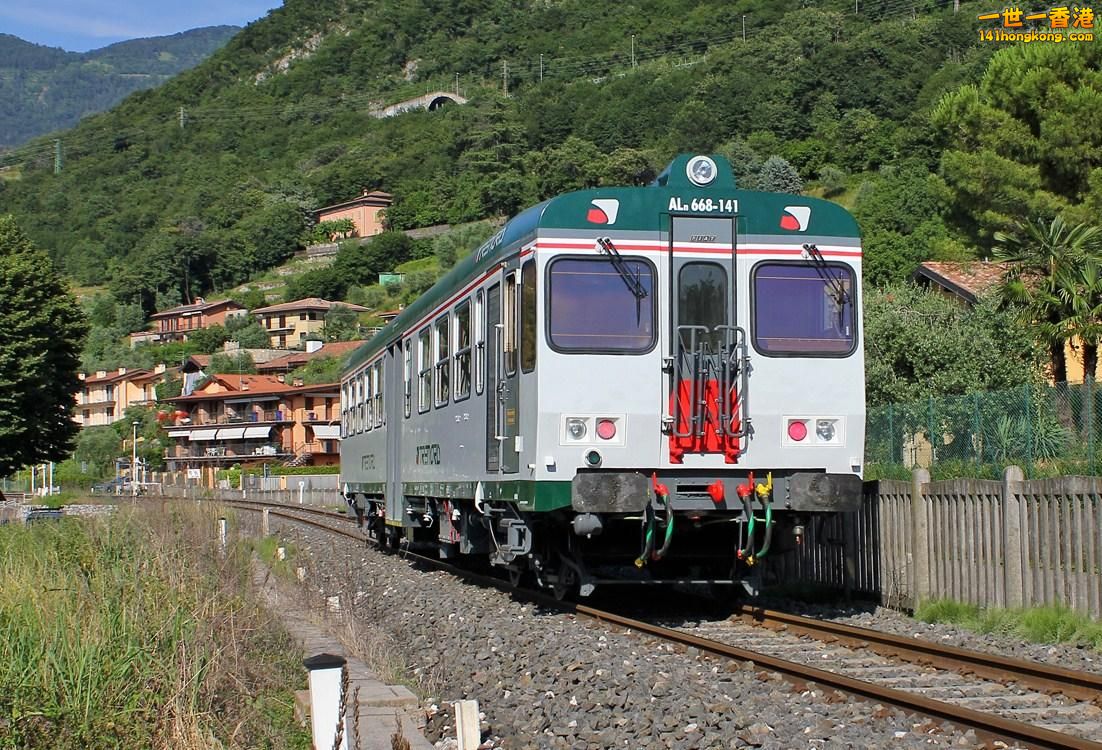 ALn668 141 of Trenord transit at Sulzano (BS) along Lake Iseo on a sunny day in .jpg