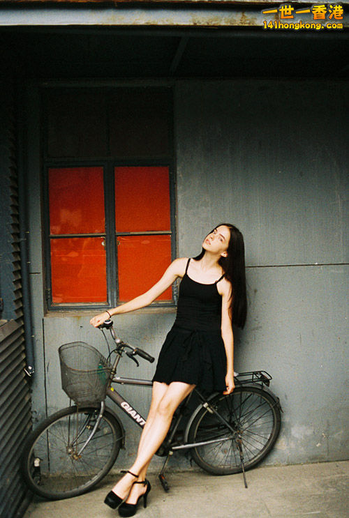 girl-young-beautiful-long-hair-dark-clothes-a-bicycle.jpg