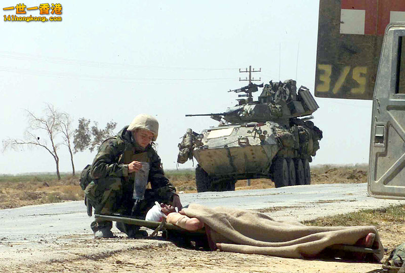 US Navy Hospital Corpsman providing treatment to a wounded Iraqi soldier, 2003..jpg