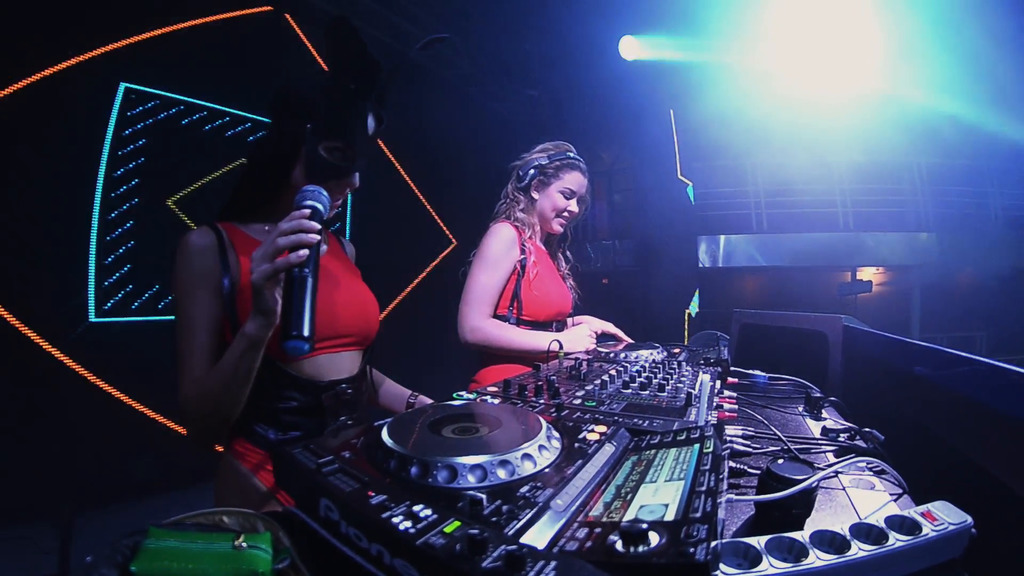 mc-girl-in-hare-mask-and-dj-girl-in-red-dress-perform-at-turntable-in-nightclub-.png
