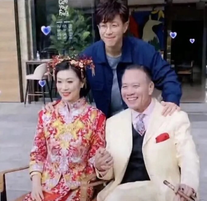 5  2022年萬梓良與太太補拍婚照時，兒子萬大千仍戴着眼鏡，甚有書卷氣。（網上片段截圖）.jpg